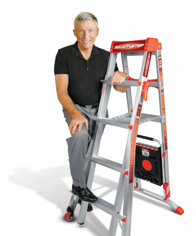 Smiling picture of Hal Wing posing with a ladder