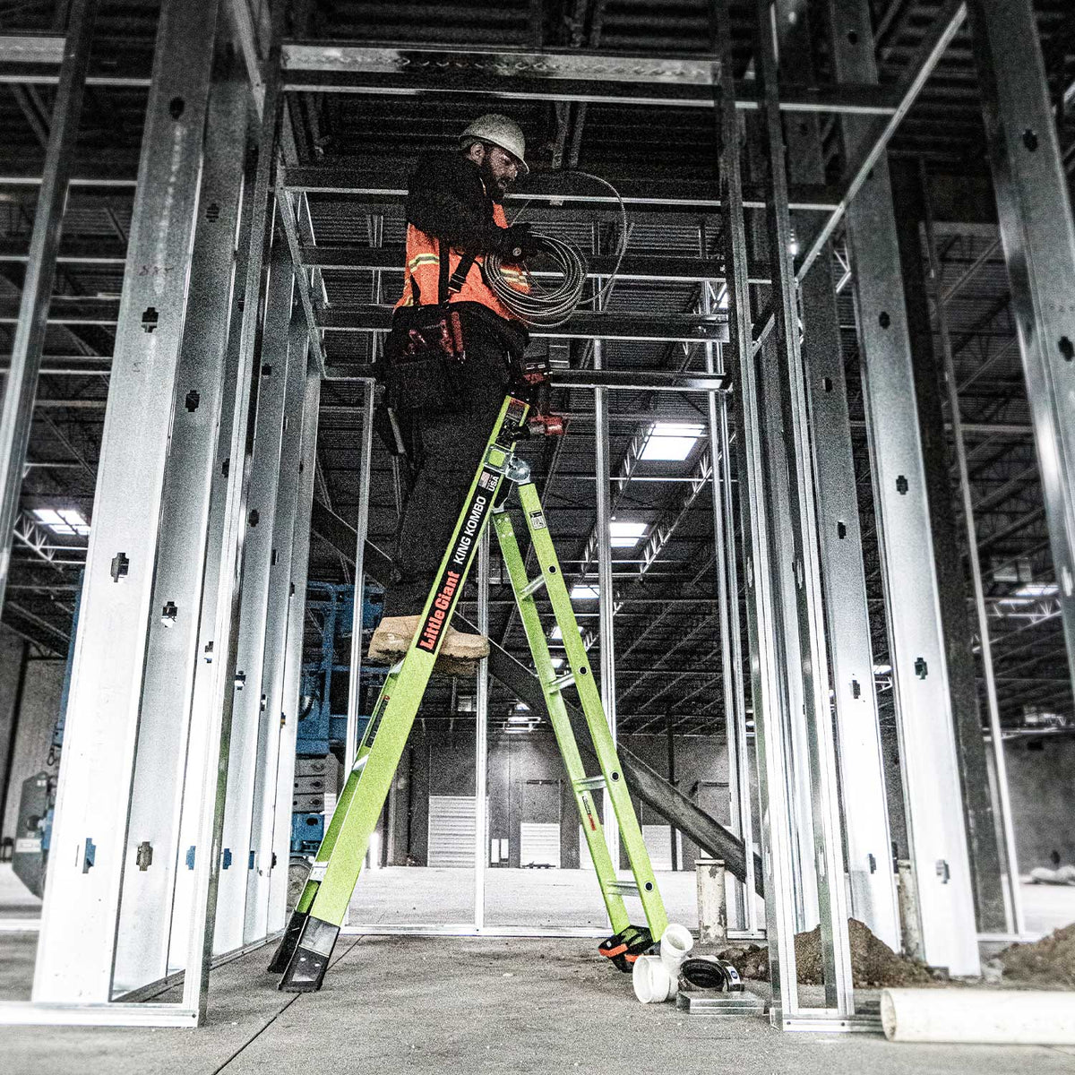 Electrician on King Kombo 2.0 ladder in a construction site