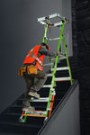 A worker in a high-visibility orange safety vest and tool belt climbs a bright green and silver fortress ladder positioned on a dark staircase.
