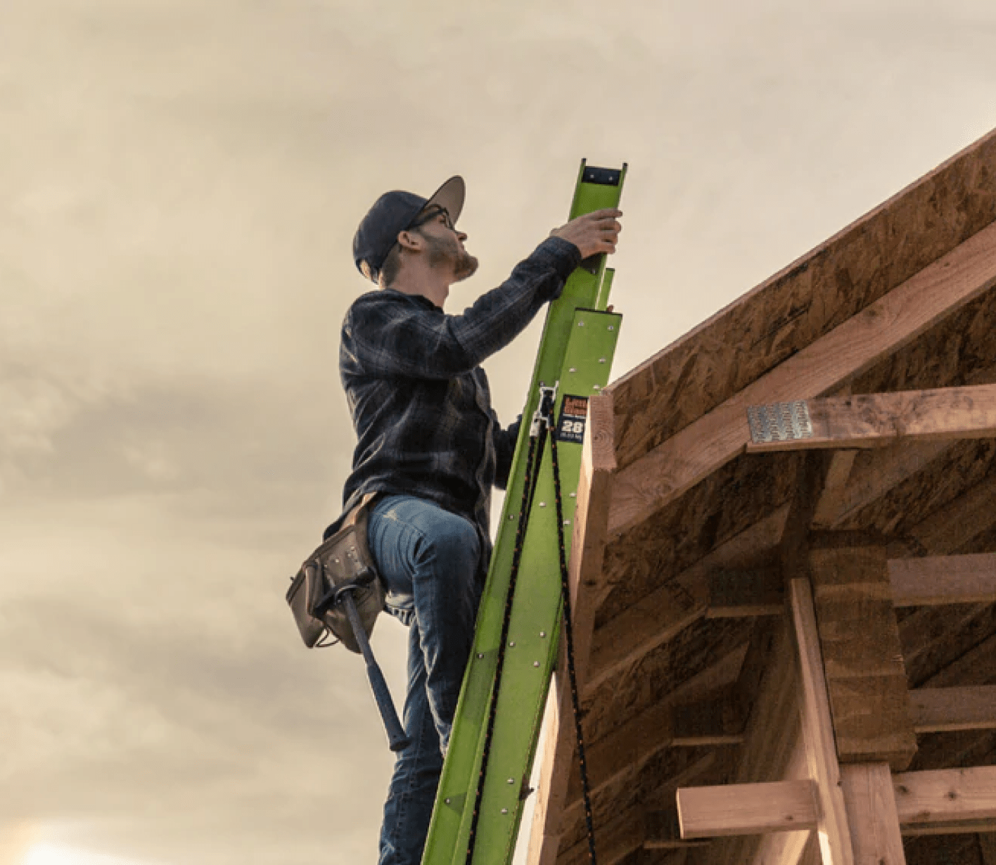 A man on the Little Giant roof ladder