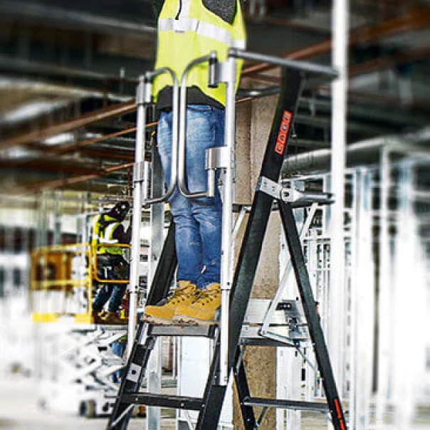 Construction worker in Little Giant Safety Cage in construction site warehouse